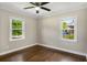 Bedroom with two windows, ceiling fan, and hardwood floors at 2288 Scotty Cir, Decatur, GA 30032
