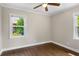 Bedroom featuring hardwood floors, ceiling fan, and two windows at 2288 Scotty Cir, Decatur, GA 30032