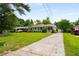 Quaint one-story home with a manicured front lawn, long driveway and inviting covered porch at 2288 Scotty Cir, Decatur, GA 30032