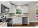 Updated kitchen with stainless steel appliances, granite countertops, and modern backsplash at 2288 Scotty Cir, Decatur, GA 30032