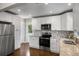 Bright kitchen with white cabinets, stainless steel appliances, and a mosaic tile backsplash at 2288 Scotty Cir, Decatur, GA 30032