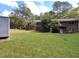 Spacious backyard featuring lush green grass and mature trees with a shed for extra storage at 3098 Henderson Mill Rd, Atlanta, GA 30341
