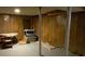 Basement featuring wood paneled walls, concrete floors, support beams, and table with chairs at 3098 Henderson Mill Rd, Atlanta, GA 30341