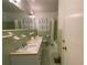 Bathroom featuring a double sink vanity, toilet, and a tub with shower and hexagon tile floor at 3098 Henderson Mill Rd, Atlanta, GA 30341
