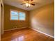 Bedroom featuring hardwood floors, neutral walls, and a window letting in natural light at 3098 Henderson Mill Rd, Atlanta, GA 30341
