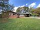 Charming brick home with a well-maintained lawn and a convenient covered carport at 3098 Henderson Mill Rd, Atlanta, GA 30341