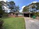 Charming brick home with a well-maintained lawn and a convenient covered carport at 3098 Henderson Mill Rd, Atlanta, GA 30341
