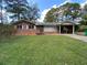 Charming brick home with a well-maintained lawn and a convenient covered carport at 3098 Henderson Mill Rd, Atlanta, GA 30341