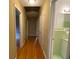 Hallway featuring hardwood floors and access to rooms with neutral paint and bright lighting at 3098 Henderson Mill Rd, Atlanta, GA 30341
