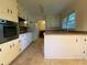 Bright kitchen with a breakfast bar, tiled floor, and modern appliances at 3098 Henderson Mill Rd, Atlanta, GA 30341