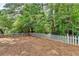 Backyard featuring a white picket fence and plenty of tree coverage at 4398 Stonebridge Ct, Duluth, GA 30096