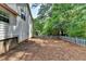 Backyard with a white picket fence that backs up to a wooded area at 4398 Stonebridge Ct, Duluth, GA 30096