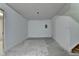 Unfinished basement featuring bare concrete flooring and a single ceiling light at 4398 Stonebridge Ct, Duluth, GA 30096