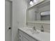 Well-lit bathroom featuring a single sink vanity and a large framed mirror at 4398 Stonebridge Ct, Duluth, GA 30096