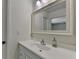 Bright bathroom features a white vanity, chrome faucet, and a large mirror at 4398 Stonebridge Ct, Duluth, GA 30096