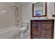 Compact bathroom with a tub/shower combo, a modern vanity, and tile accents at 4398 Stonebridge Ct, Duluth, GA 30096