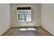 Simple bedroom showcasing a bright window and neutral carpeting at 4398 Stonebridge Ct, Duluth, GA 30096