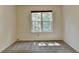 Empty bedroom featuring neutral carpeting, natural light from the window and fresh paint at 4398 Stonebridge Ct, Duluth, GA 30096