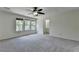 This large bedroom features new carpet, a ceiling fan, and natural light at 4398 Stonebridge Ct, Duluth, GA 30096