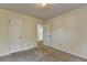 Bright bedroom with neutral carpet, white walls, and a closet door at 4398 Stonebridge Ct, Duluth, GA 30096
