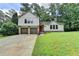 Charming two-story home with a well-manicured lawn, two-car garage, and bright red front door at 4398 Stonebridge Ct, Duluth, GA 30096