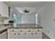 Eat-in kitchen with island, stainless appliances, slider to backyard, and ceiling fan at 4398 Stonebridge Ct, Duluth, GA 30096