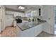 Bright kitchen featuring granite countertops, white cabinets, stainless steel appliances, and tile flooring at 4398 Stonebridge Ct, Duluth, GA 30096