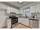Bright traditional kitchen features white cabinets and stainless steel appliances at 4398 Stonebridge Ct, Duluth, GA 30096