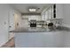 Traditional kitchen featuring white cabinets, granite countertops, and tiled flooring at 4398 Stonebridge Ct, Duluth, GA 30096