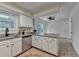 Eat-in kitchen with island, stainless appliances, slider to backyard, and ceiling fan at 4398 Stonebridge Ct, Duluth, GA 30096