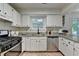 Bright traditional kitchen features white cabinets and stainless steel appliances at 4398 Stonebridge Ct, Duluth, GA 30096