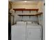 Laundry room with overhead shelving and washer and dryer units at 4398 Stonebridge Ct, Duluth, GA 30096