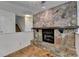 Charming living room showcasing a stone fireplace with a rustic wooden mantel at 4398 Stonebridge Ct, Duluth, GA 30096
