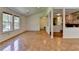 Inviting living room featuring hardwood floors, large windows, and a cozy stone fireplace for a warm ambiance at 4398 Stonebridge Ct, Duluth, GA 30096