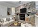 Inviting living room with stone fireplace, a flatscreen television and neutral colored sofa at 4398 Stonebridge Ct, Duluth, GA 30096