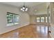 Bright living room with hardwood floors, multiple windows, high ceilings, and a view of the landscaped yard at 4398 Stonebridge Ct, Duluth, GA 30096