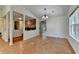 Bright living room featuring hardwood floors, a stone fireplace, and natural light from large windows at 4398 Stonebridge Ct, Duluth, GA 30096