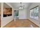 Spacious living room featuring hardwood floors, stone fireplace, and natural light from the large window at 4398 Stonebridge Ct, Duluth, GA 30096