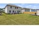 Large backyard with green grass, privacy fence, patio with a grill, and a modern shed at 7207 Gladstone Cir, Stonecrest, GA 30038