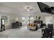 Expansive bedroom featuring ceiling fan, neutral walls, large windows, and a sitting area at 7207 Gladstone Cir, Stonecrest, GA 30038