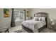 Cozy bedroom with a comfortable queen-sized bed, neutral decor, and natural light from the window at 7207 Gladstone Cir, Stonecrest, GA 30038