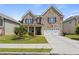Charming two-story brick home with a well-manicured lawn and attached two-car garage at 7207 Gladstone Cir, Stonecrest, GA 30038