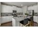 Modern kitchen with granite countertops, white cabinets, and stainless steel appliances for cooking at 7207 Gladstone Cir, Stonecrest, GA 30038