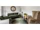 Cozy living room featuring plush sofas, a round mirror, and decorative accents for a comfortable setting at 7207 Gladstone Cir, Stonecrest, GA 30038