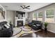 Inviting living room with a fireplace, large windows, and comfortable recliners for relaxing at 7207 Gladstone Cir, Stonecrest, GA 30038