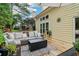 Relaxing outdoor deck with comfortable seating, a fire pit, and lush greenery, creating a tranquil outdoor living space at 1006 Amberton Ln, Powder Springs, GA 30127