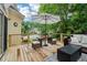 Inviting outdoor deck features cozy seating, a dining set, and a peaceful view, perfect for entertaining and relaxation at 1006 Amberton Ln, Powder Springs, GA 30127