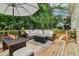 Spacious back deck features a cozy seating area, dining set, and green surroundings, perfect for outdoor enjoyment at 1006 Amberton Ln, Powder Springs, GA 30127