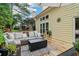 Back deck with seating, pillows, throw, firepit and view of backyard at 1006 Amberton Ln, Powder Springs, GA 30127