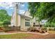Backyard view of a home with a deck, stone landscaping, and mature trees at 1006 Amberton Ln, Powder Springs, GA 30127